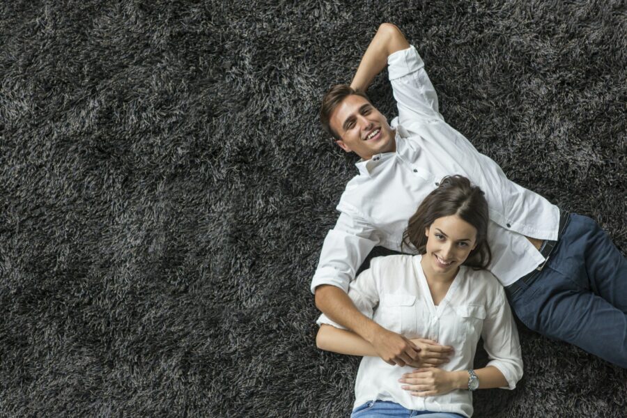 Young couple relaxing on fresh carpet